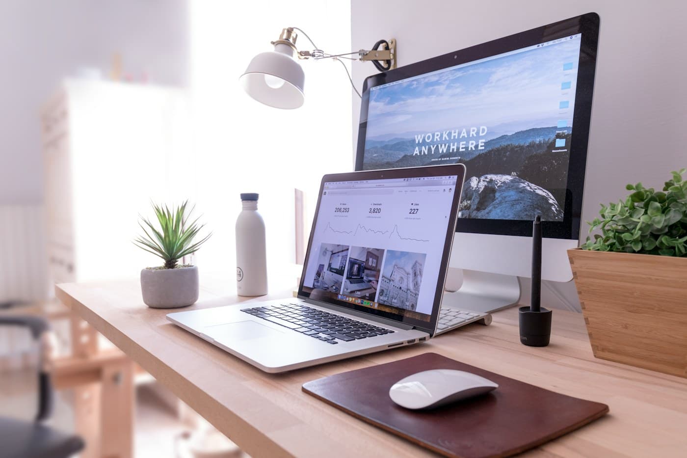 Desktop computer and design materials in a workspace