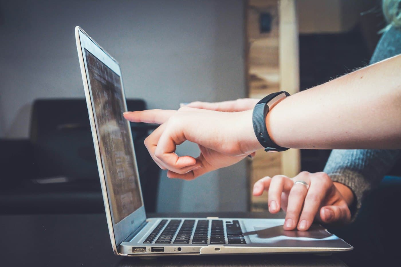 People reviewing a digital project on a laptop