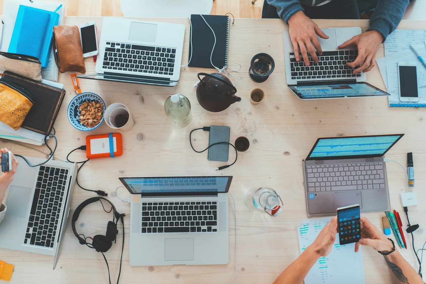 Shared workspace with laptops, notebooks and project materials